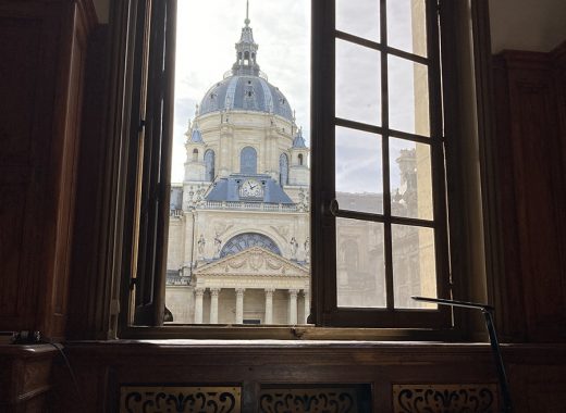 widok przez okno na sąsiedni budynek z okrągłą kopułą